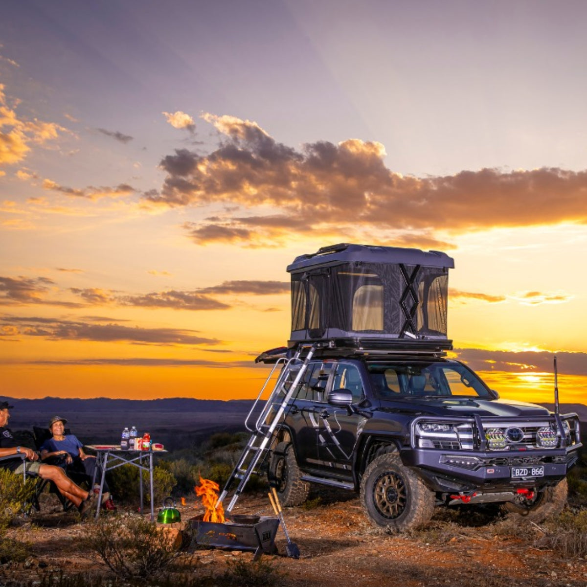 Roof top tent on a truck with sunset landscape