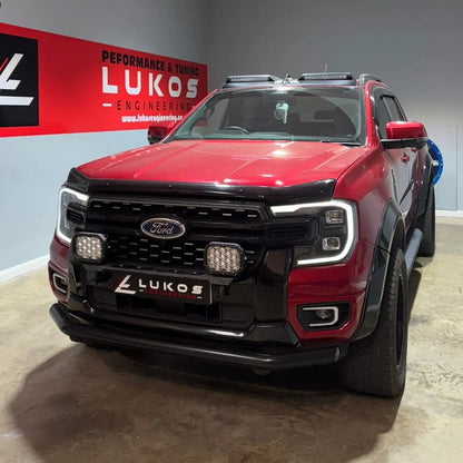 Red Ford SUV with black bumper and Lukos Engineering branding in a showroom.