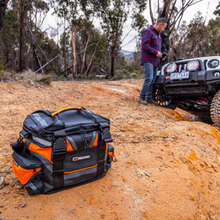 ARB Premium Recovery Kit bag on a dirt track with a 4x4 behind